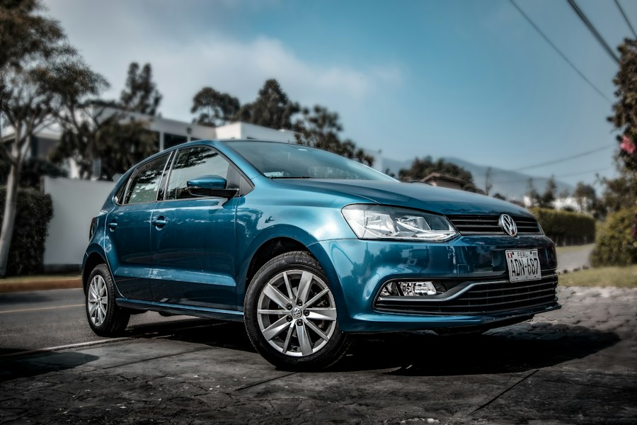 A blue hatchback parked on a city street
