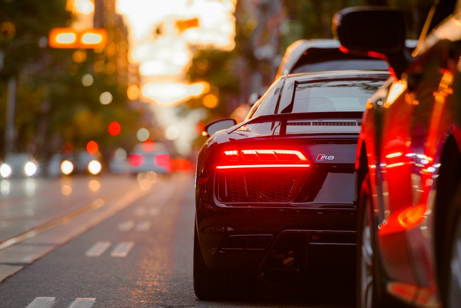 Car taillights glowing on a city street at dusk